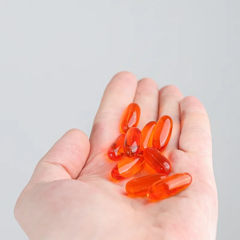 капсулы омега 3 на руке